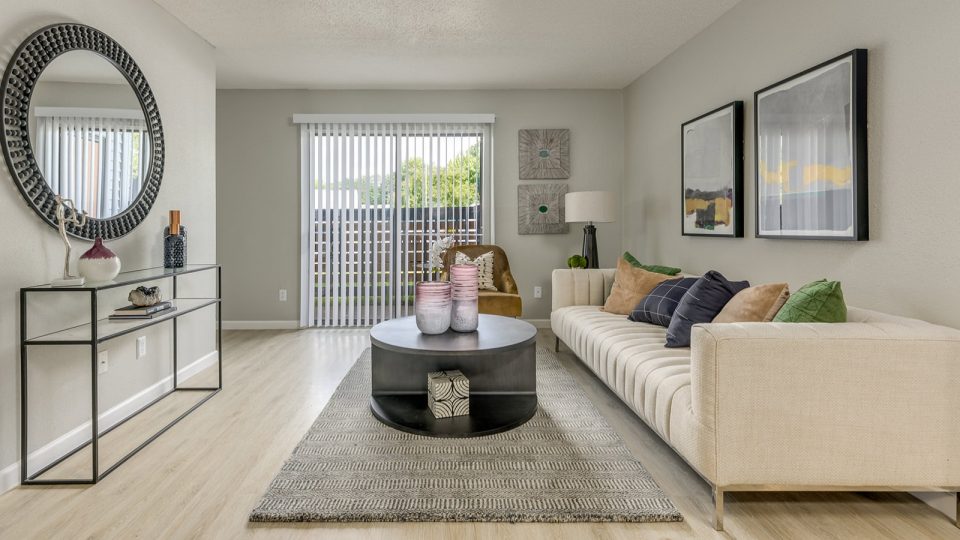 a living room with a couch, coffee table and mirror at The Grant Valley Ranch