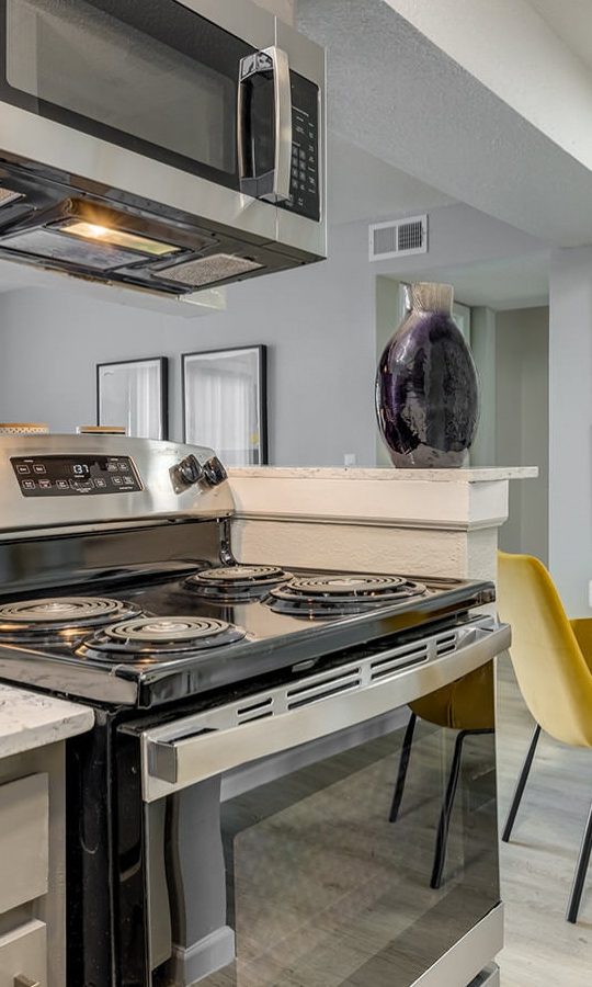 kitchen with stainless steel appliances and yellow chairs at The Grant Valley Ranch