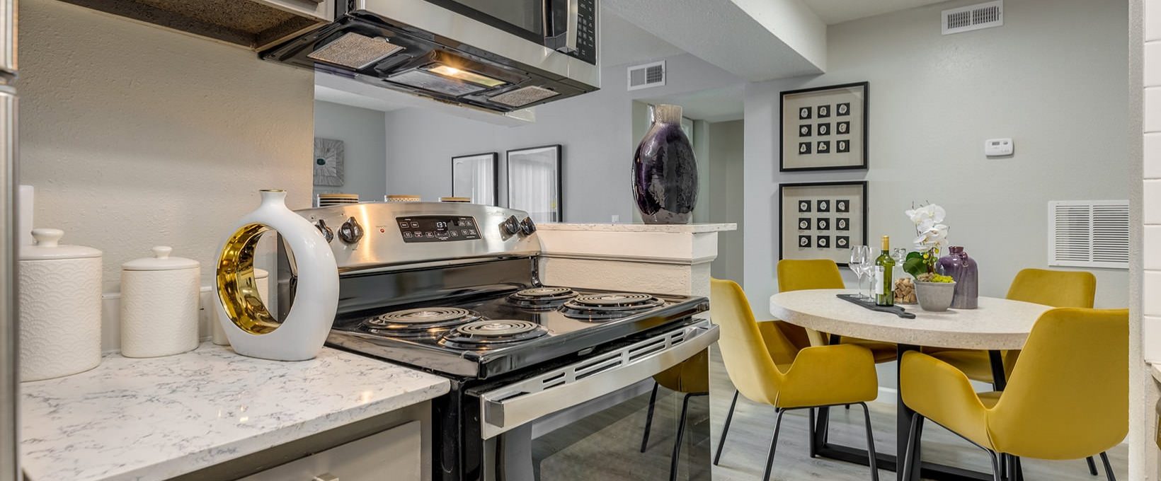 kitchen with stainless steel appliances and yellow chairs at The Grant Valley Ranch
