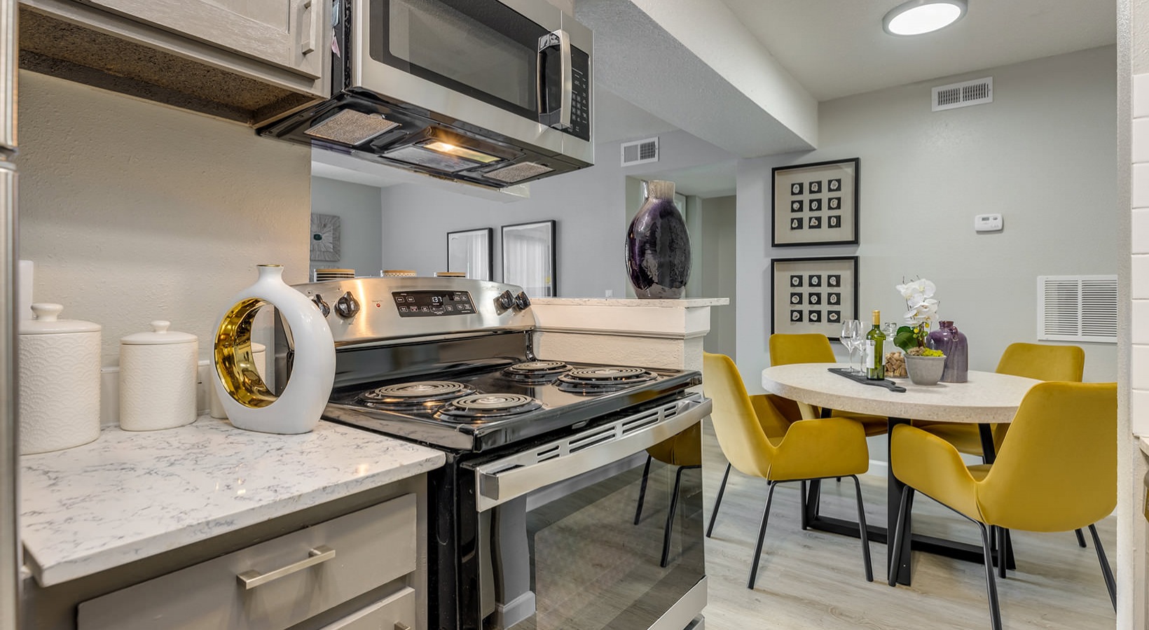 kitchen with stainless steel appliances and yellow chairs at The Grant Valley Ranch