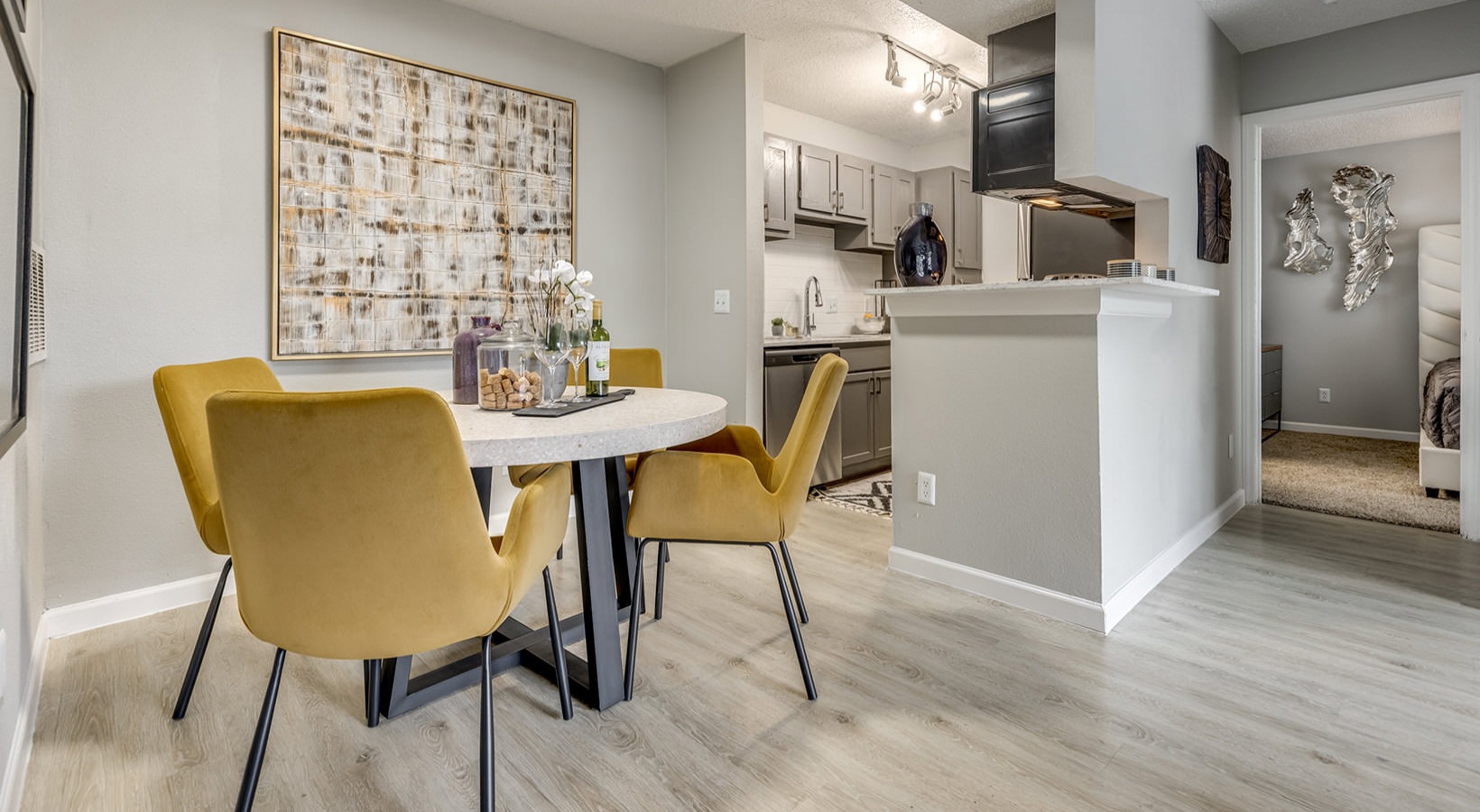 a dining room and kitchen area with yellow chairs at The Grant Valley Ranch