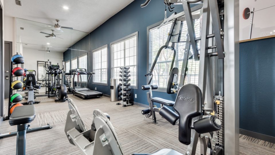 a gym room with exercise equipment and mirrors at The Grant Valley Ranch