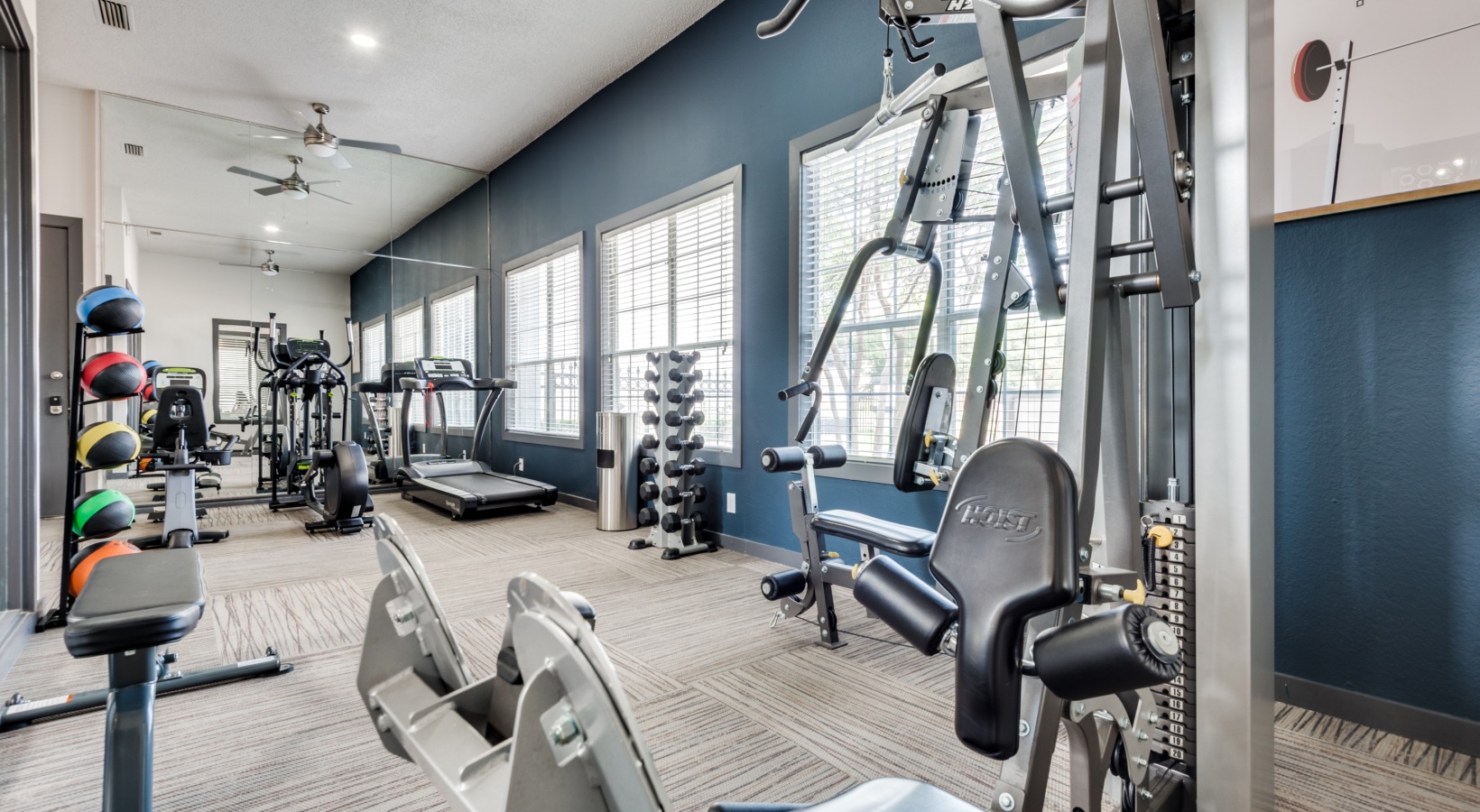 a gym room with exercise equipment and mirrors at The Grant Valley Ranch